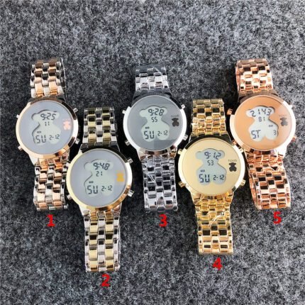 TOUS watch with circular peach silk bear pattern and needle free design. The dial has a metal steel band and multiple colors to choose from